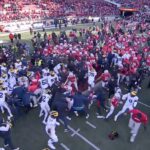 Michigan and Ohio State players brawl at midfield after the Wolverines' win in The Game.